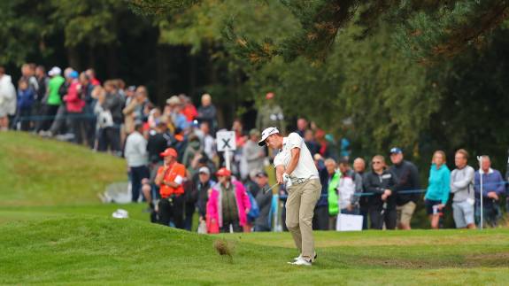 A crowd watches Andrew Putnam play a shot at the BMW PGA Championship
