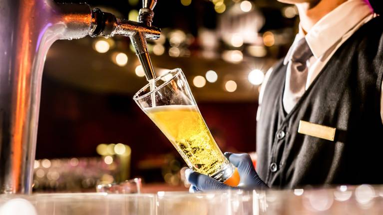 A glass of beer being poured