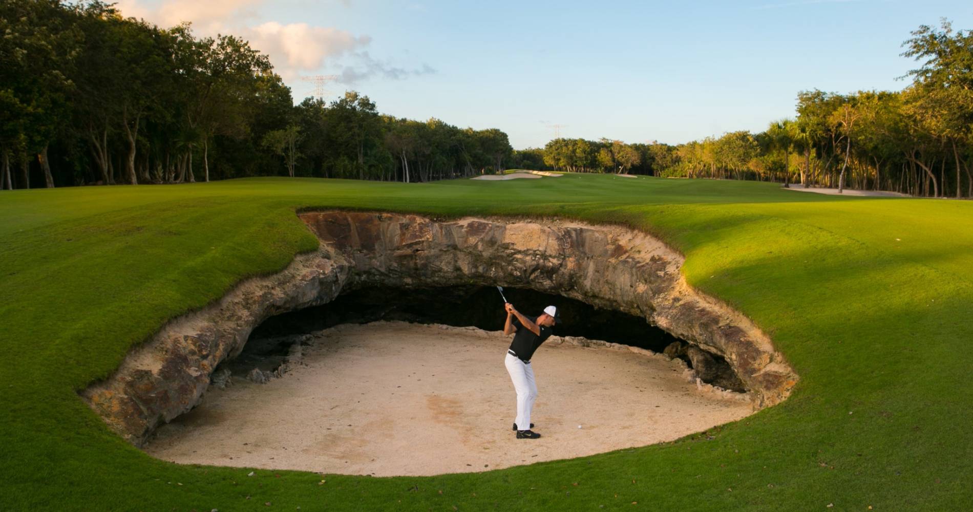A golfer playing at El Cameleon Golf Club Mayakoba