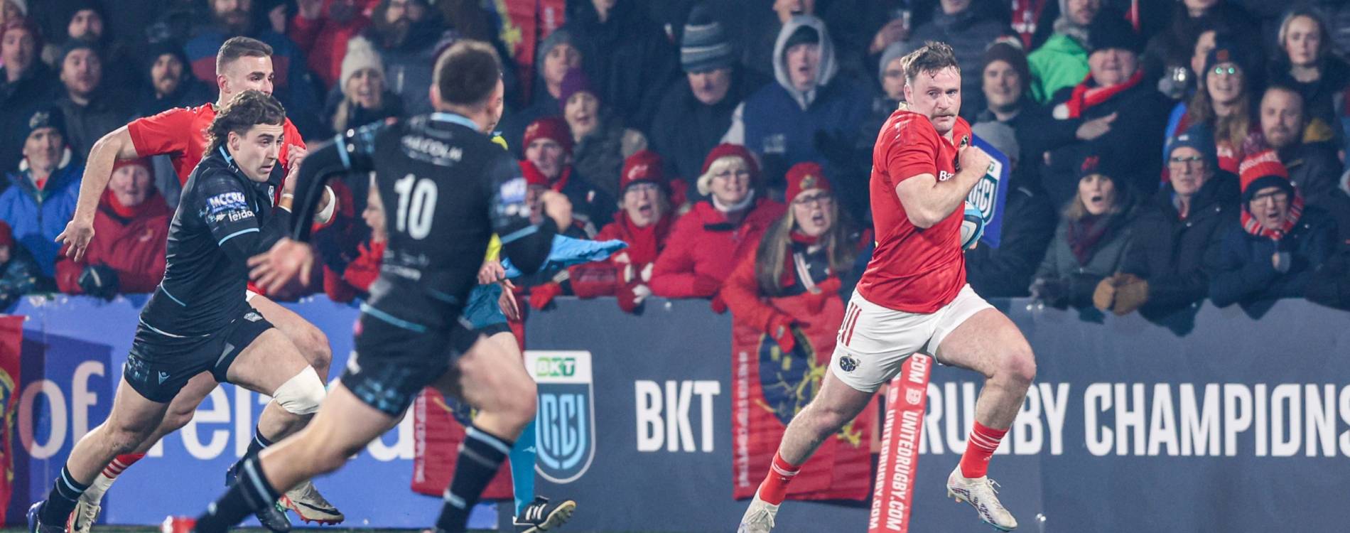 A Munster player runs for the try line