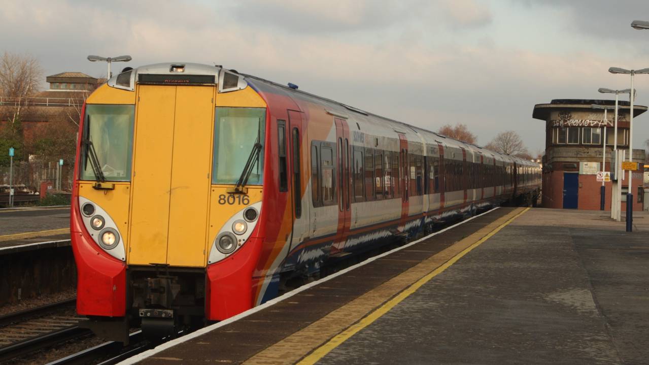 A National Rail service travelling through Wimbledon station