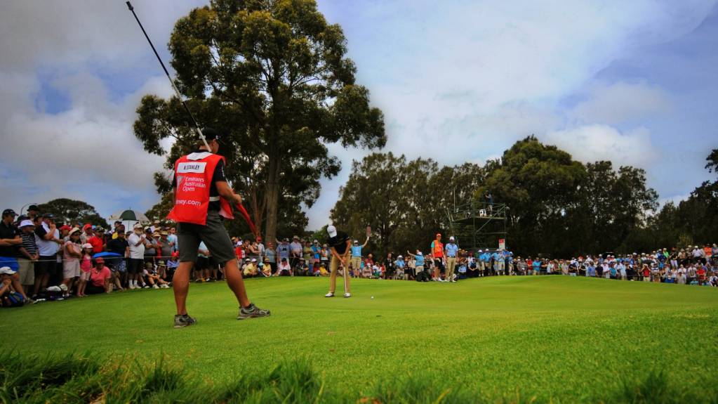 A player sinks a putt at the Australian Open