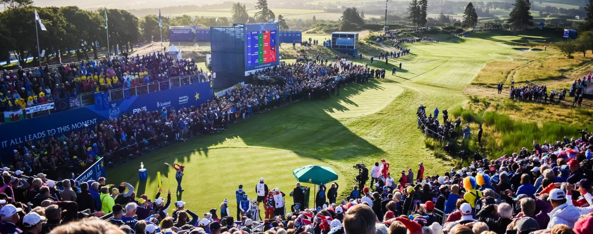 A player tees off in front of an enormous crowd at the Solheim Cup
