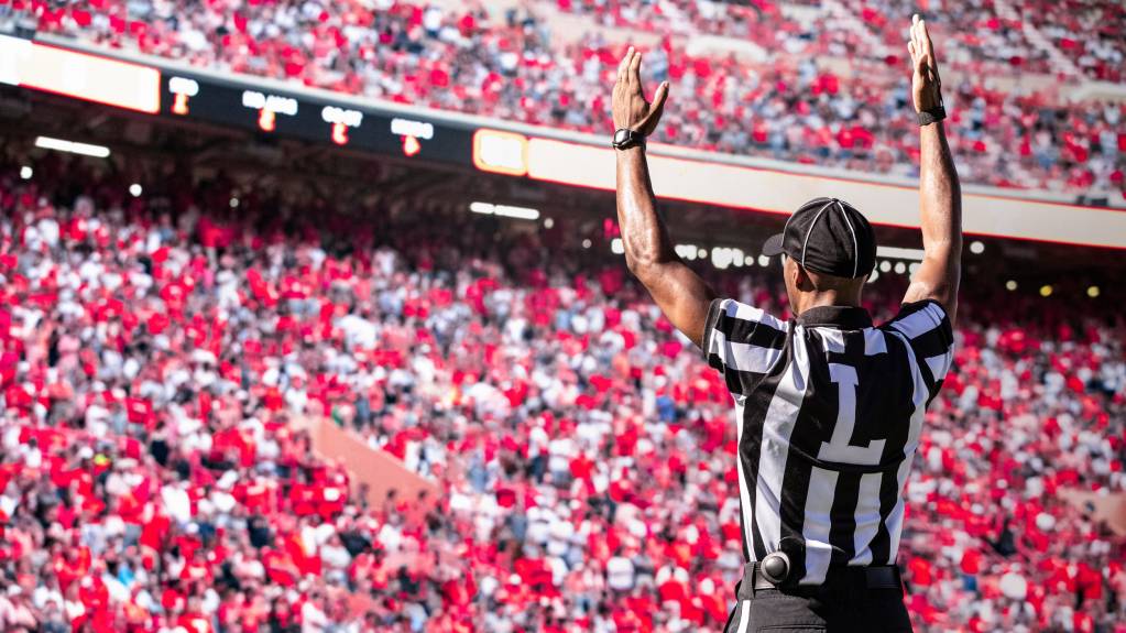 A referee signals for a touchdown