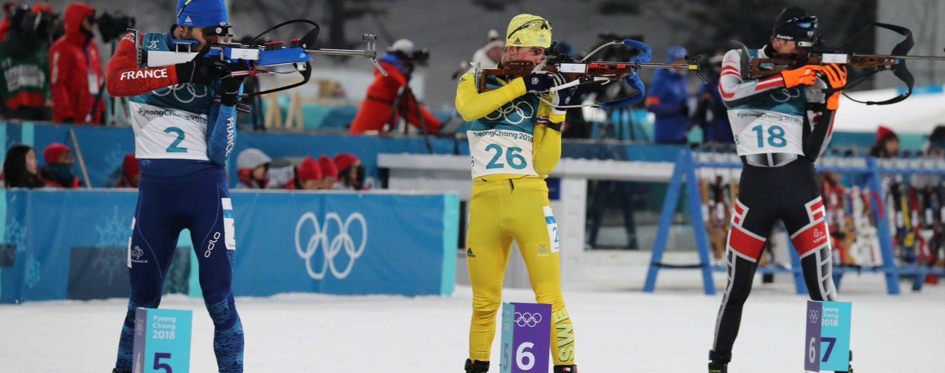 Biathlon competitors shooting