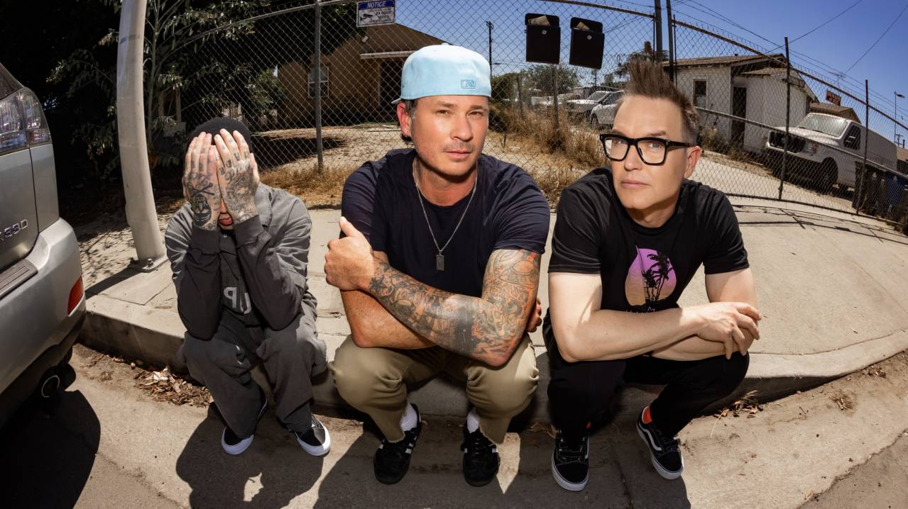 Blink-182 members Mark Hoppus, Tom DeLonge and Travis Barker pose together