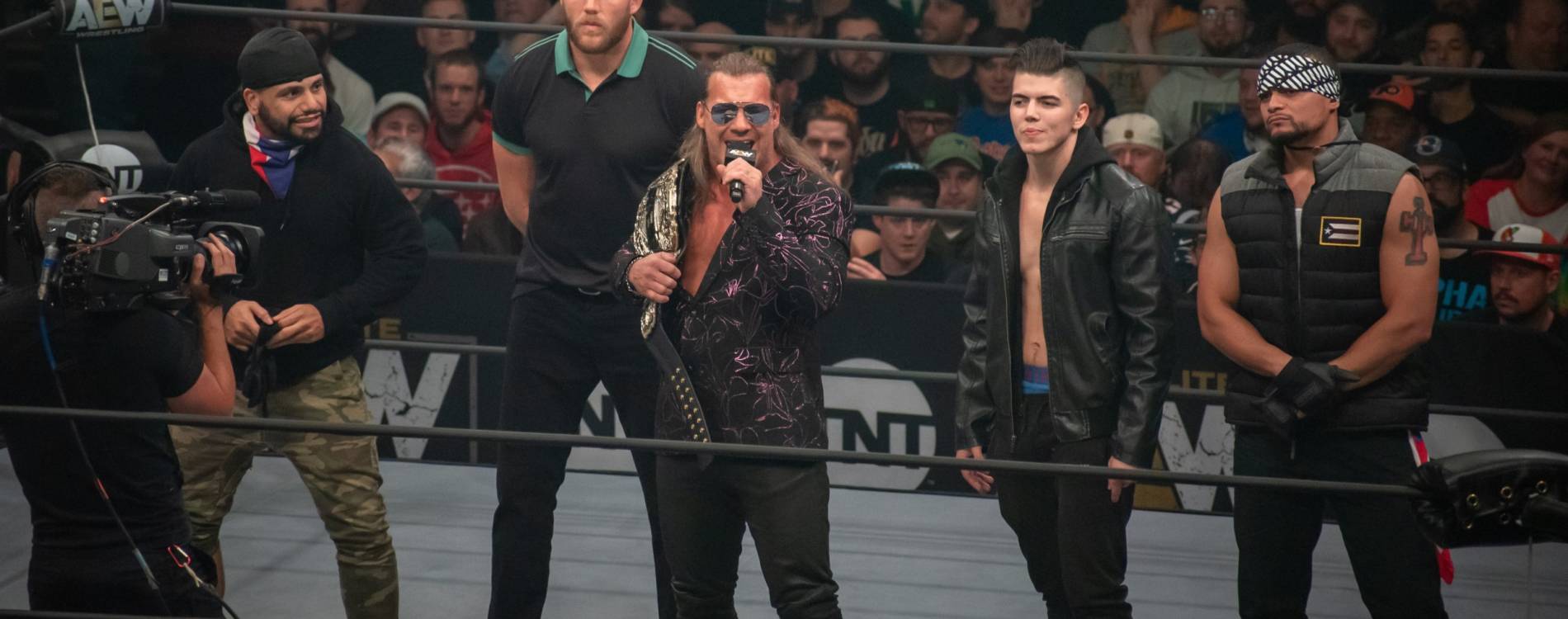 Chris Jericho (center) will face England's Will Ospreay at All In on Sunday
