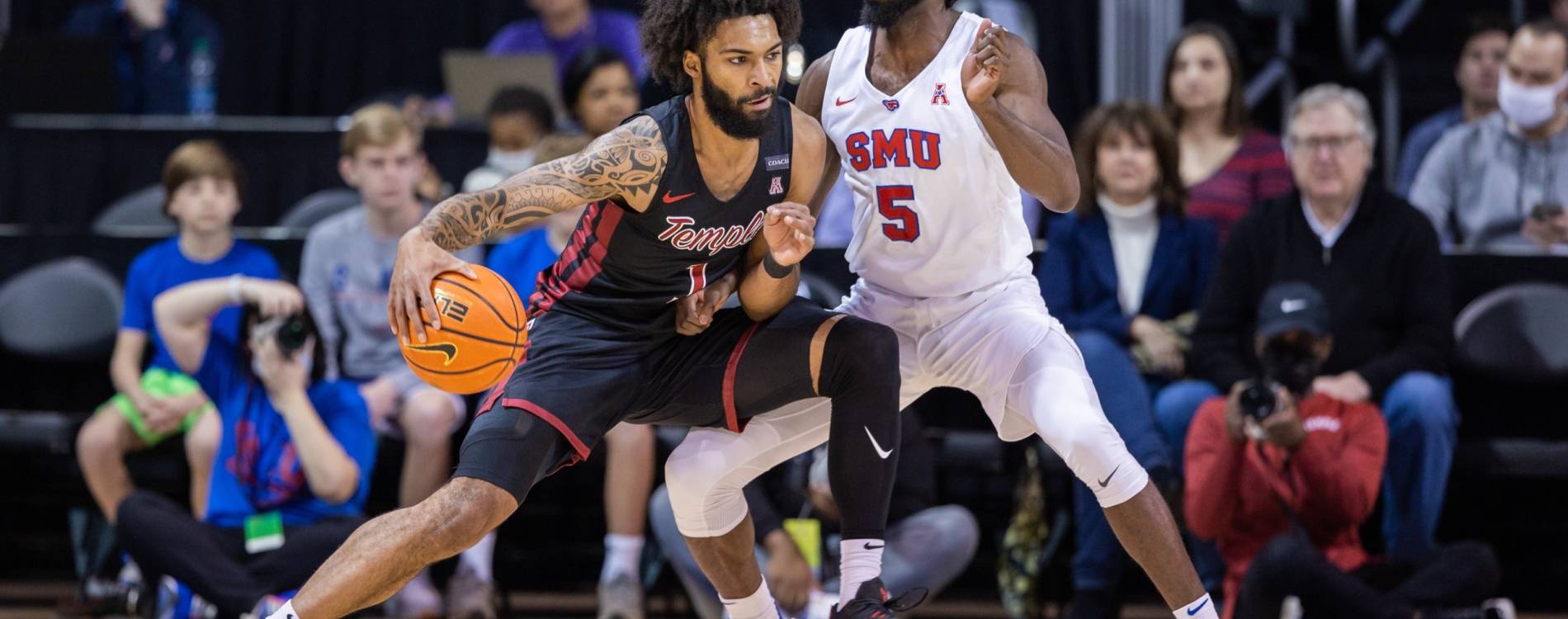 Damian Dunn of the Temple Owls dribbles past Southern Methodist guard Emmanuel Bandoumel