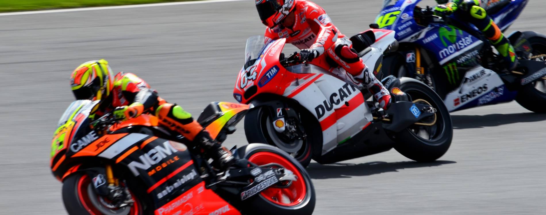 Espargaro, Dovizioso, and Rossi racing at the British Motorcycle Grand Prix