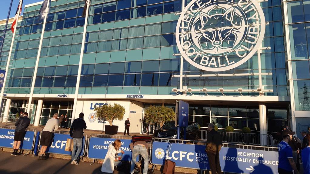 Fans await the arrival of the team bus at Leicester City's King Power Stadium