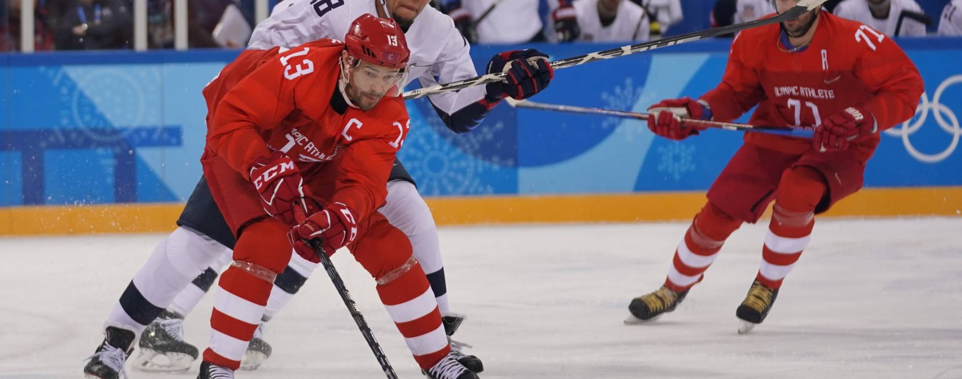 Ice hockey players fighting over the puck