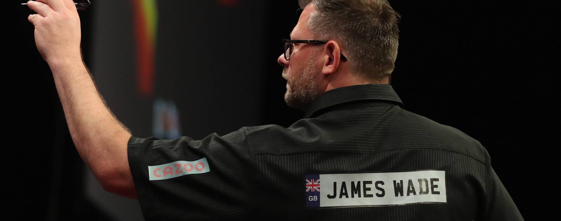 James Wade competing during a Premier League Darts event
