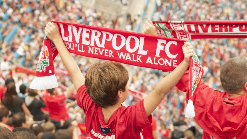 Liverpool fans hold up scarves