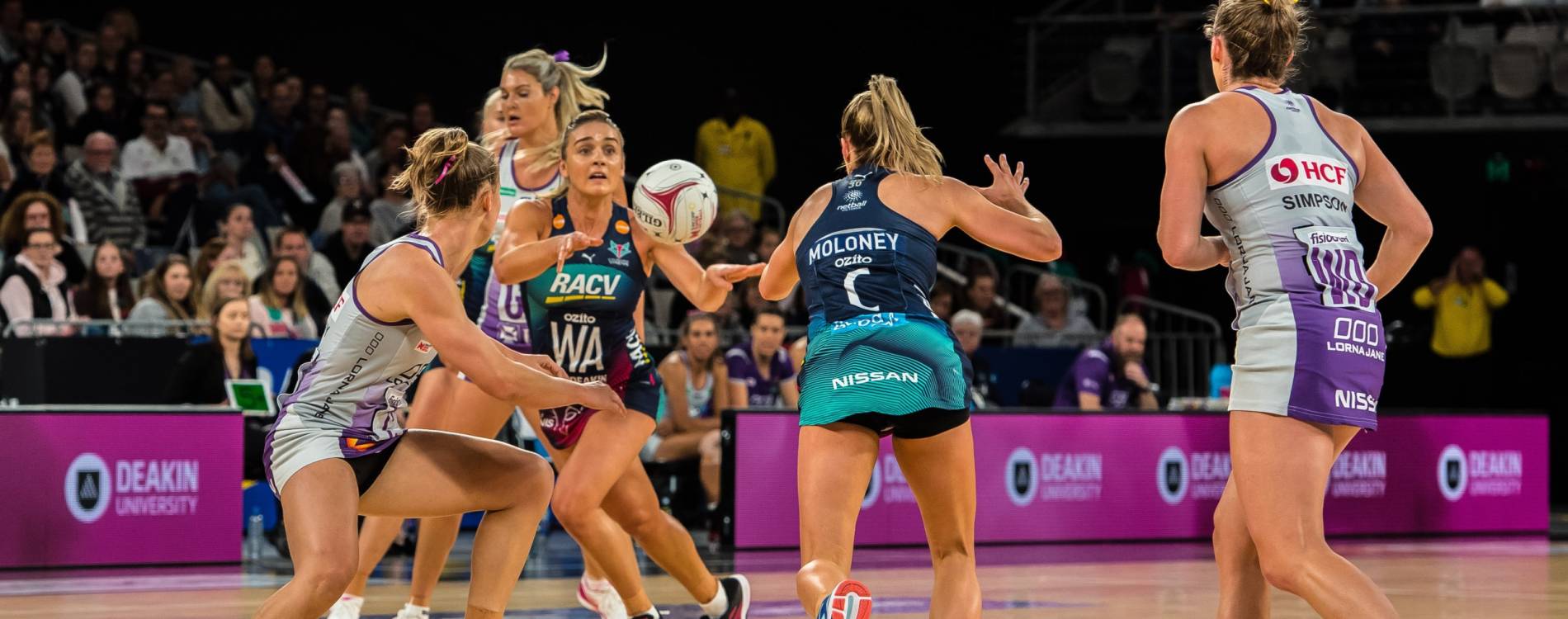 Melbourne Vixens pass the ball in a Suncorp Super Netball league match