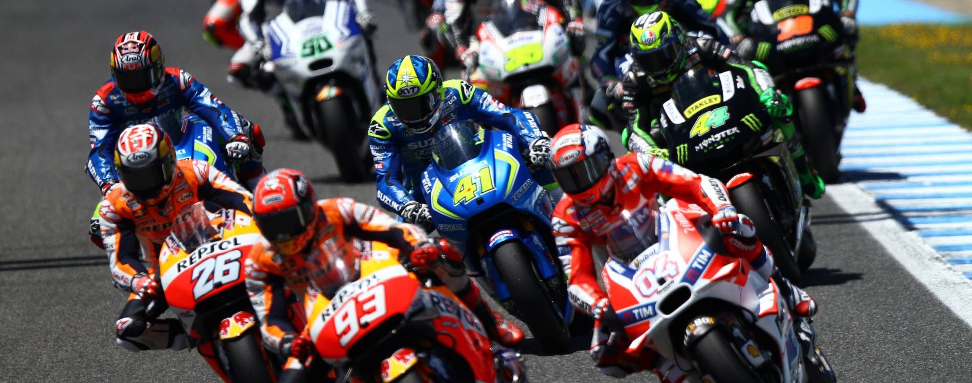 MotoGP riders cluster together during a race