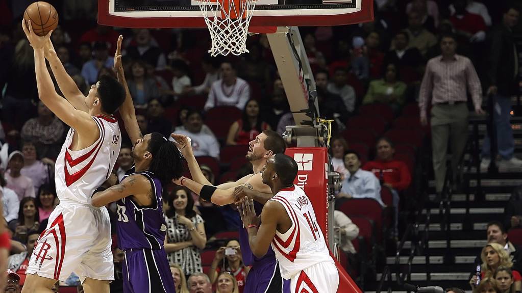 Players compete for the ball in an NBA game