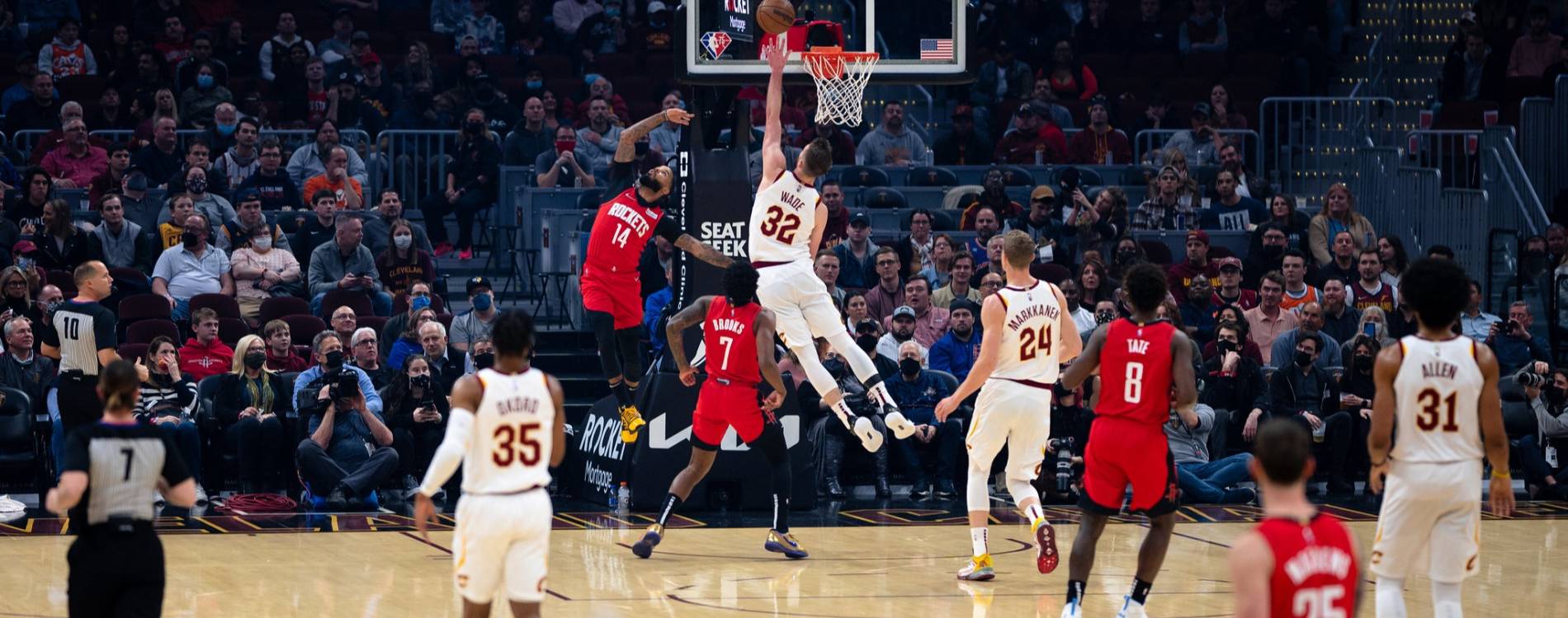 Players compete for the ball in an NBA game