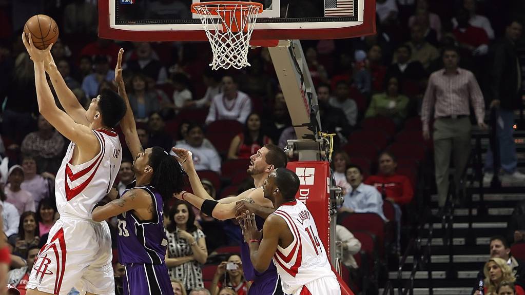 Players compete for the ball in an NBA game
