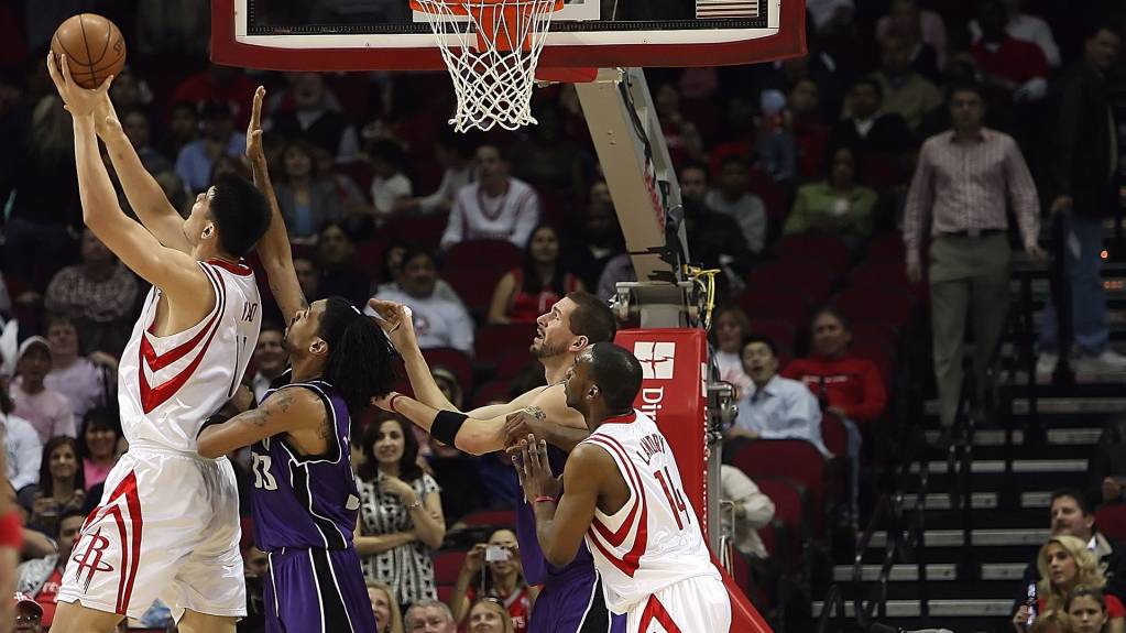 Players compete for the ball in an NBA game