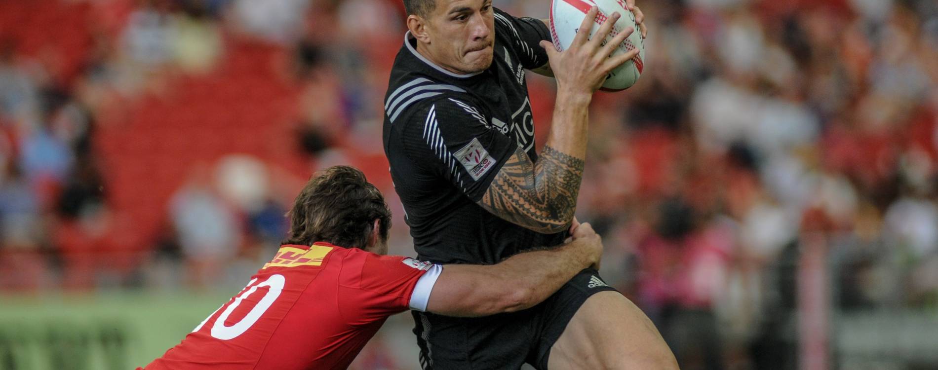 Rugby Sevens players wrestle for the ball