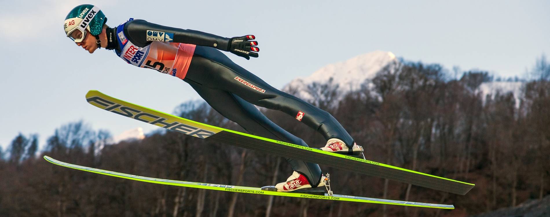Ski jumper with mountain background