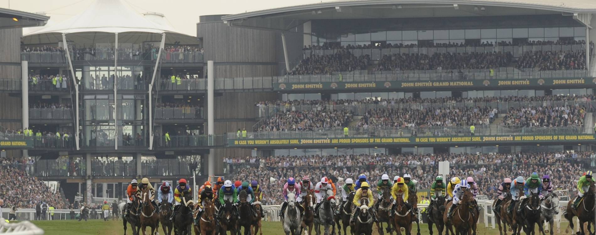 The Grand National in front of Aintree's stands