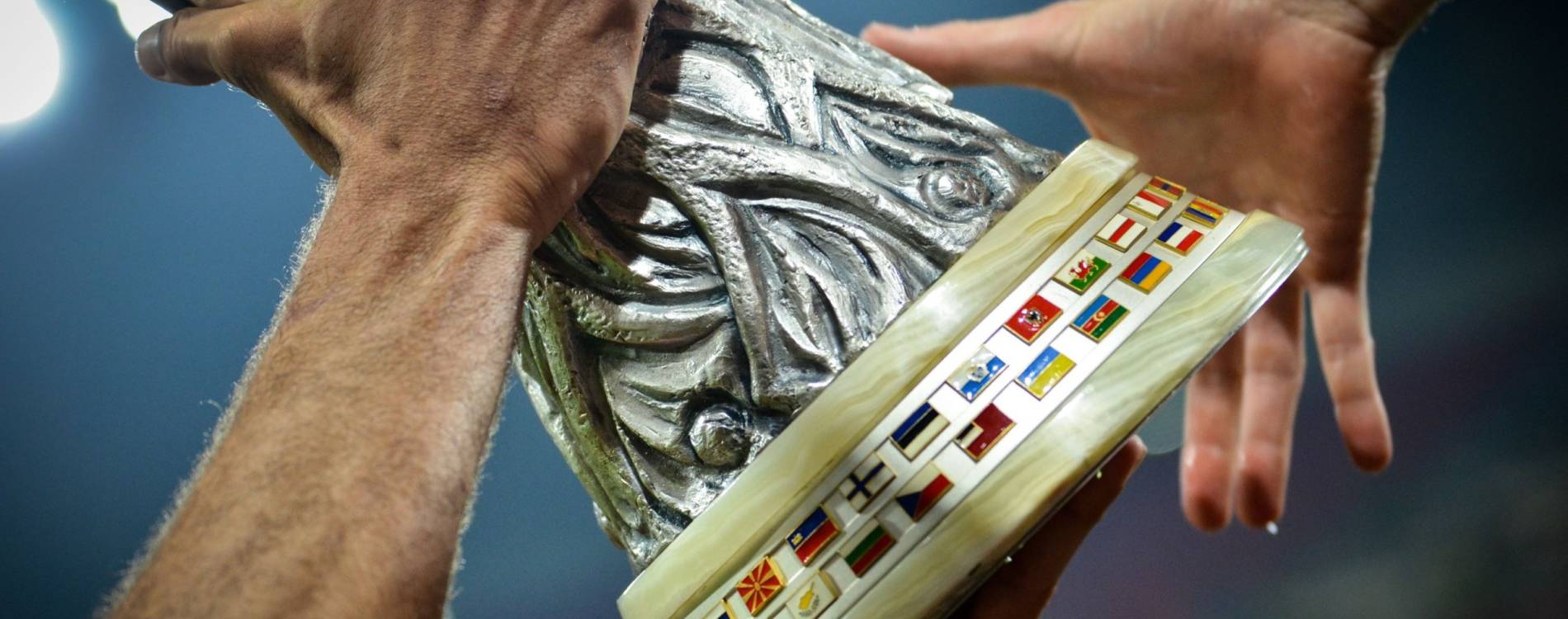 The UEFA Europa League Cup is passed between players