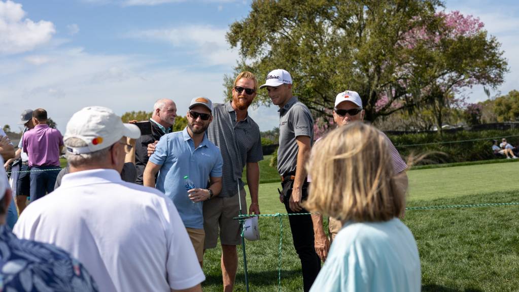 Will Zalatoris poses for photos with fans during the practice rounds of the Arnold Palmer Invitational
