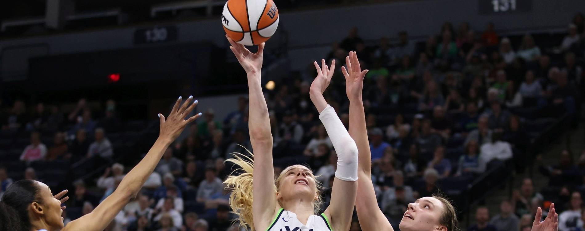 WNBA players contest the ball